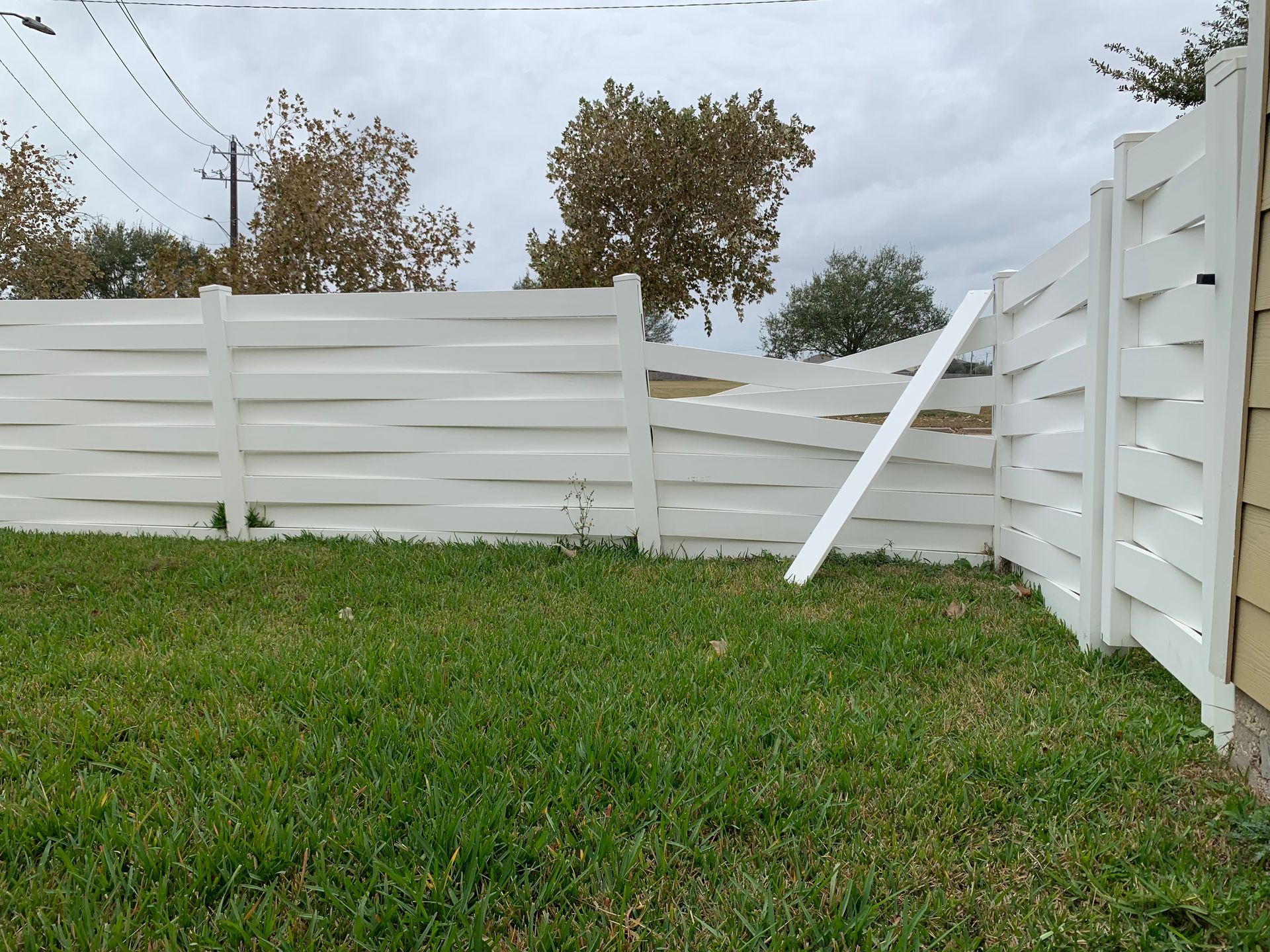Kitchen with wood cabinets, stainless steel refrigerator, and tiled counter.