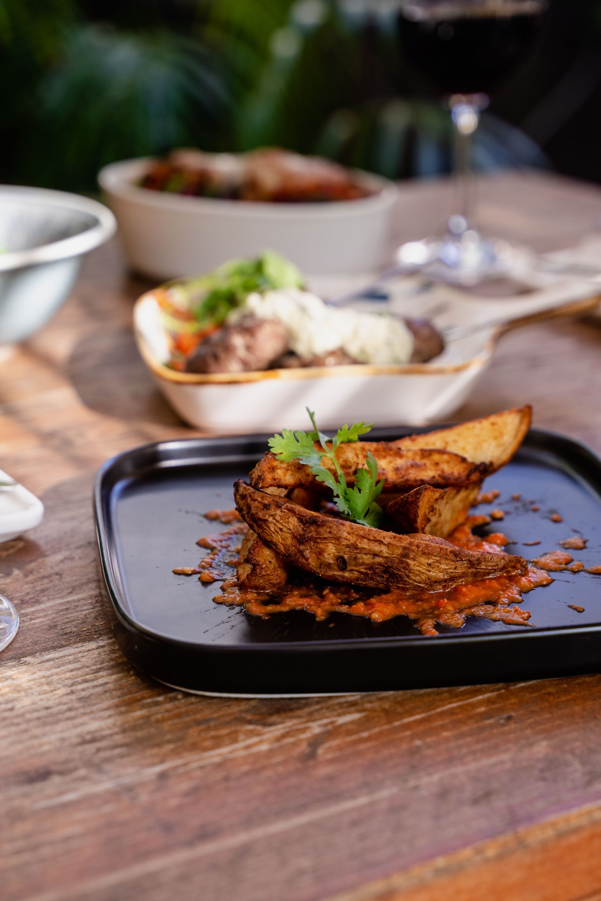A close up of a plate of food on a wooden table.