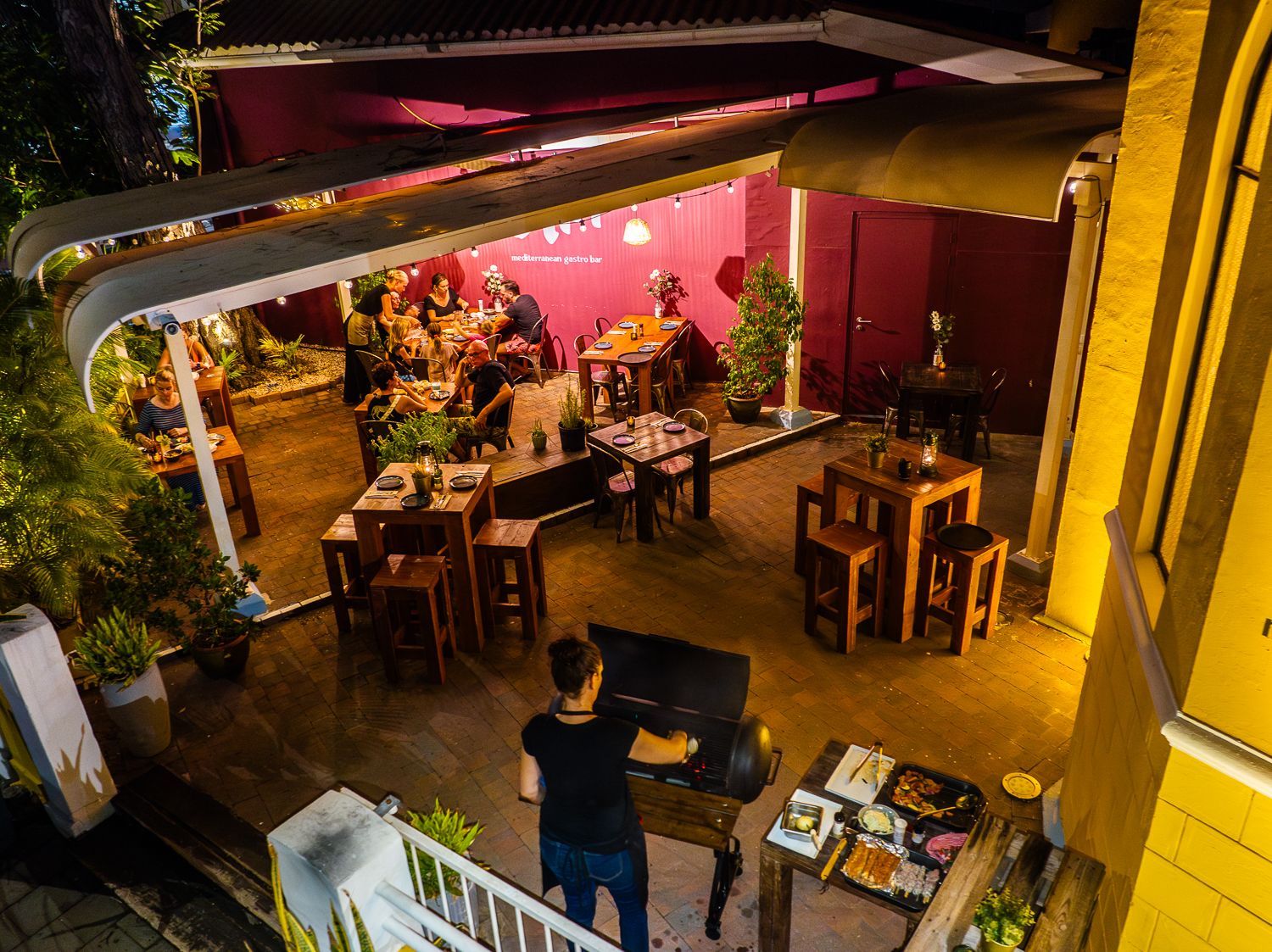 A white plate topped with shrimp and squid next to a bowl of dipping sauce.