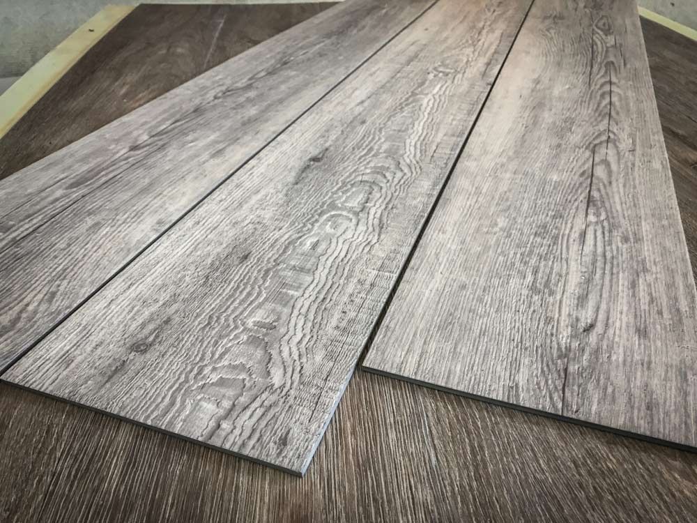 Three Pieces of Wood Are Laying on Top of Each Other on a Table — Bayside Carpets & Flooring in Bonny Hills, NSW