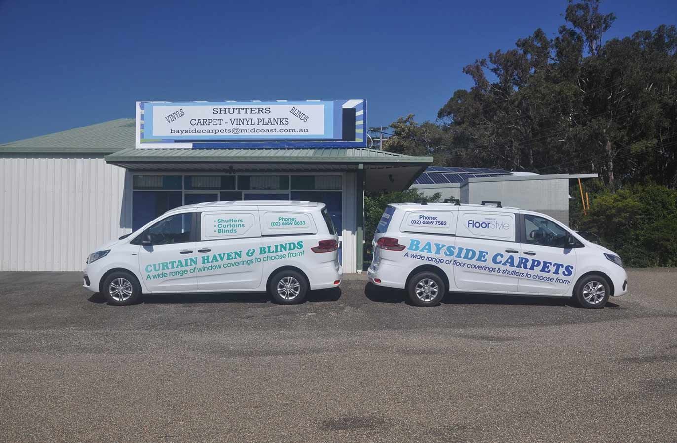 Two White Vans Are Parked in Front of a Building — Bayside Carpets & Flooring in Laurieton, NSW