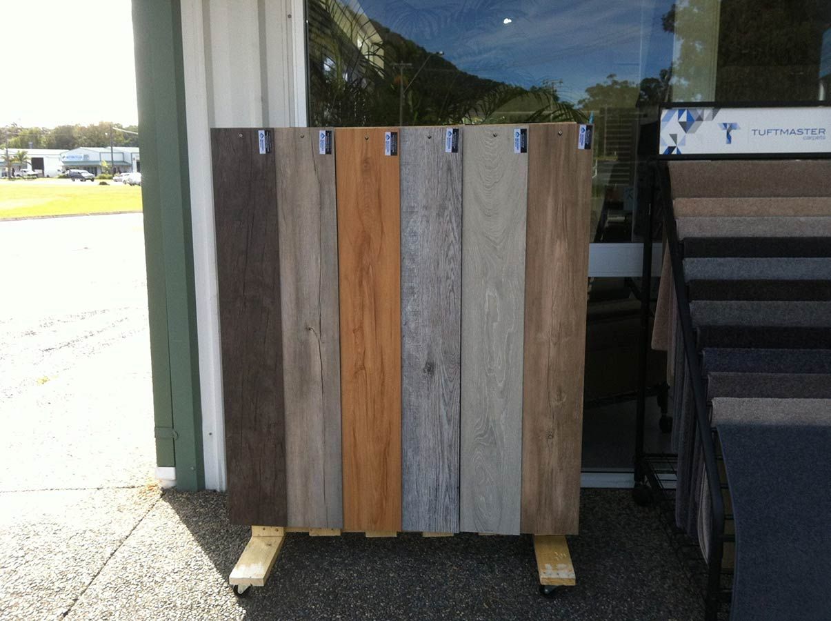 A Display of Different Types of Wooden Flooring in Front of a Window — Bayside Carpets & Flooring in Kendall, NSW