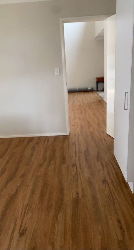 A Room With a Wooden Floor and a Doorway Leading to Another Room — Bayside Carpets & Flooring in Harrington, NSW