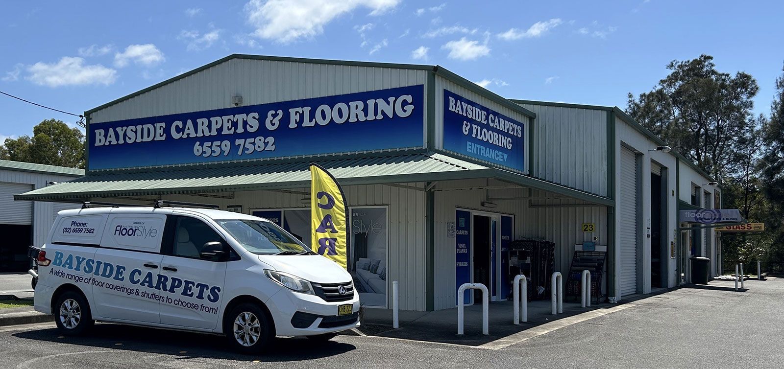 A White Van is Parked in Front of a Building — Bayside Carpets & Flooring in Laurieton, NSW