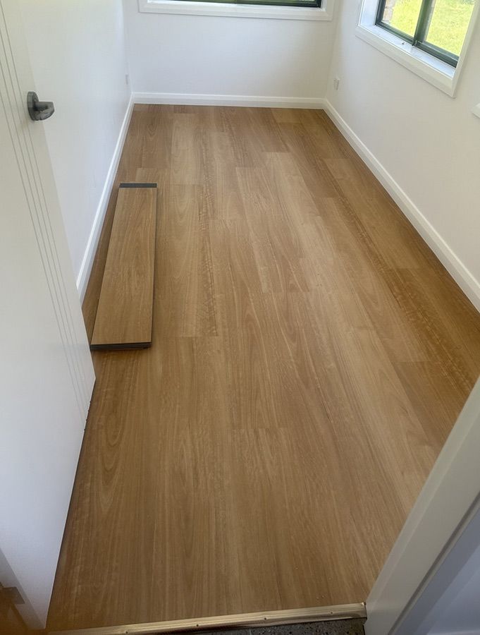 A Room With a Wooden Floor and a Window — Bayside Carpets & Flooring in Harrington, NSW