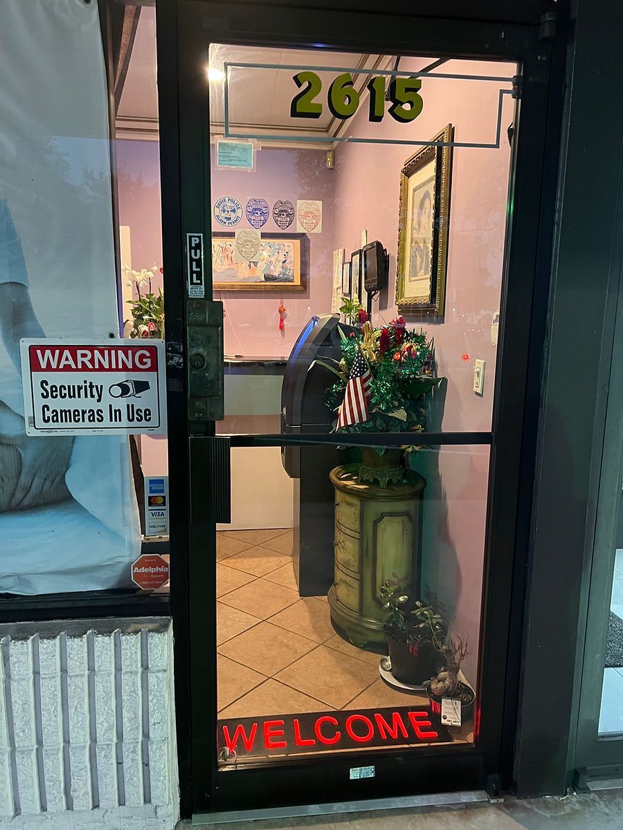 A store front with a welcome sign on the door