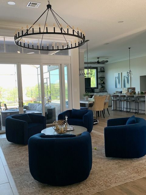 Modern living room with green accent wall, armchair, and decorative shelving
