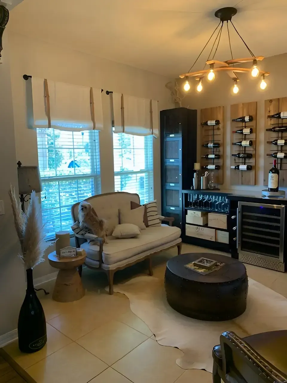 Modern living room with green accent wall, armchair, and decorative shelving