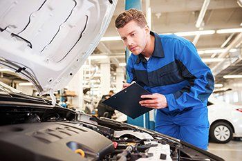 Mechanic inspecting vehicle  - Vehicle Inspection in Layton, UT