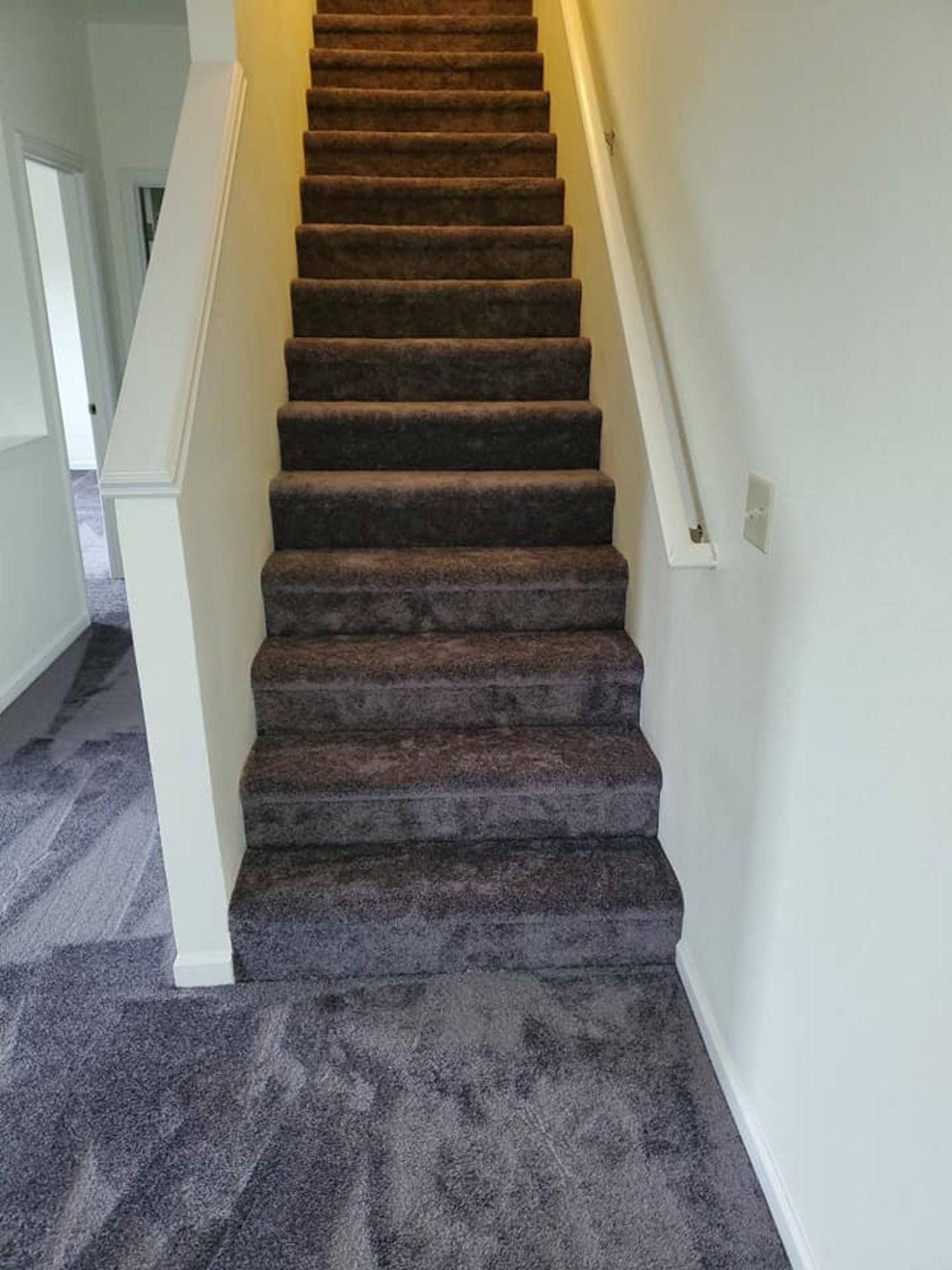 A set of stairs leading up to the second floor of a house.