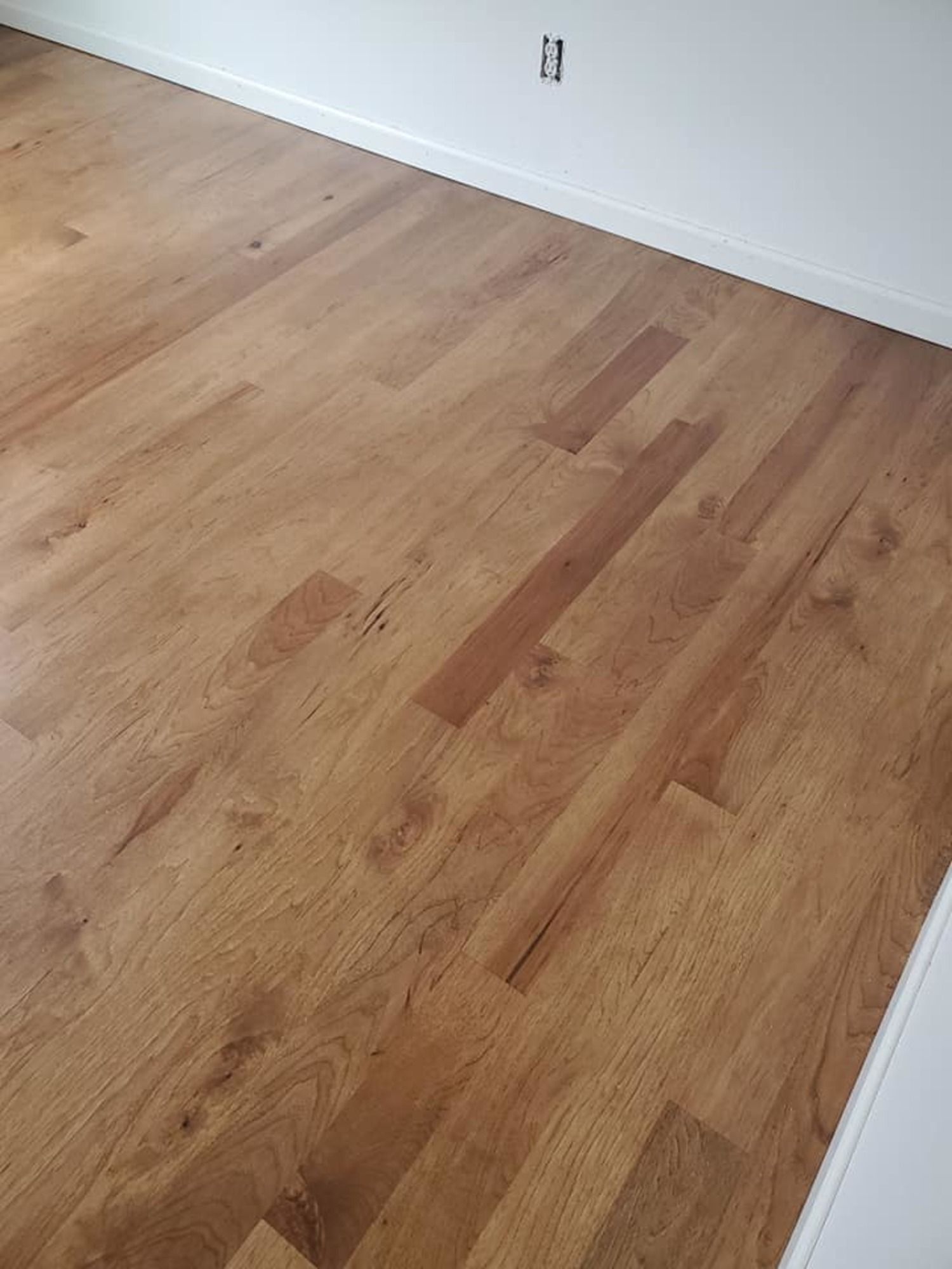 A close up of a wooden floor in a room.