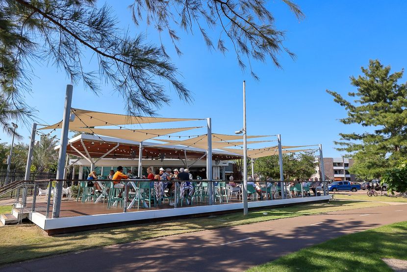 Outdoor carousel with people riding under a blue sky, shaded by a white canopy in a park — Invision NT in Gove, NT