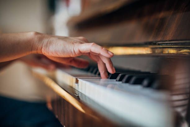 Hand Touching Piano — Tully, NY — Tritone Pianos