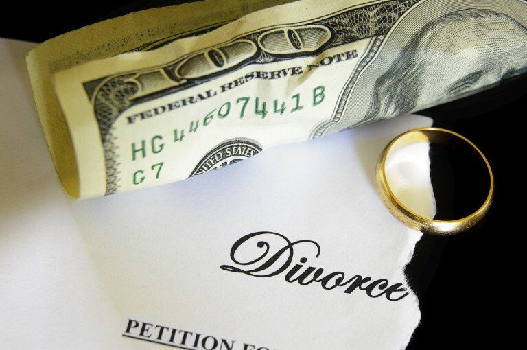 100 dollar bill next to a ring and a divorce paper