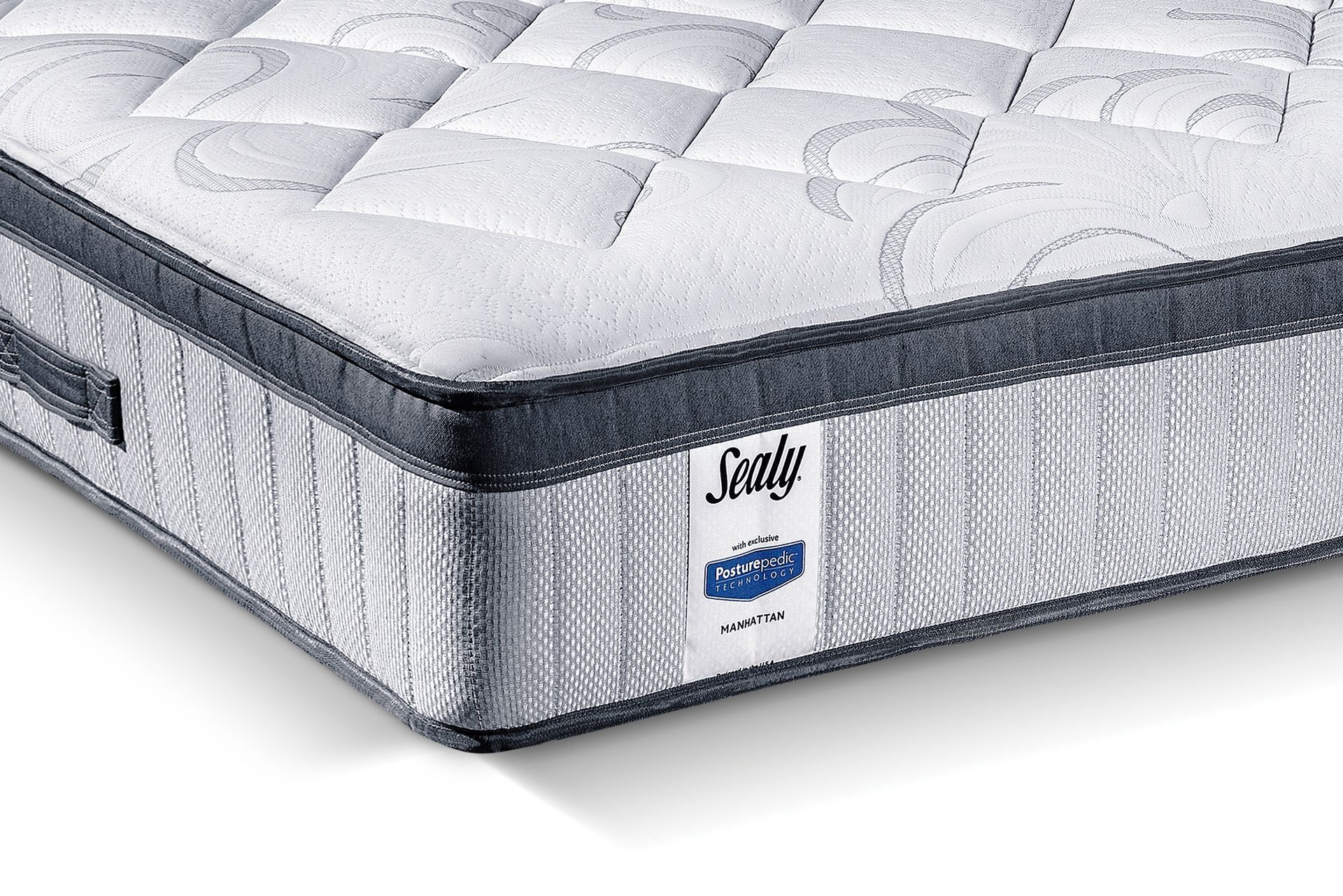A sealy mattress is sitting on a white surface.