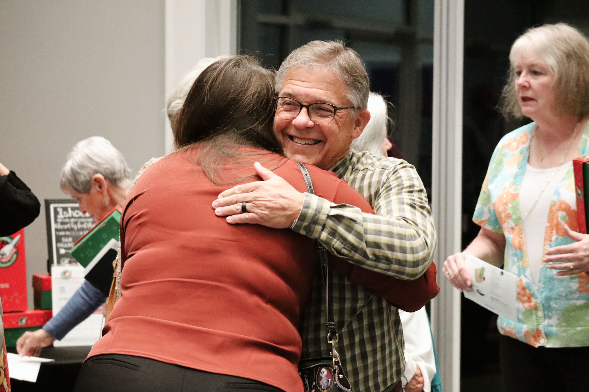 A man is hugging a woman in a room.