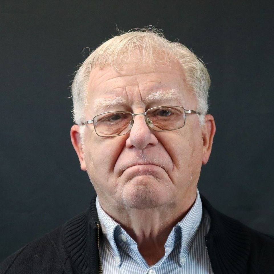 A man wearing glasses and a striped shirt