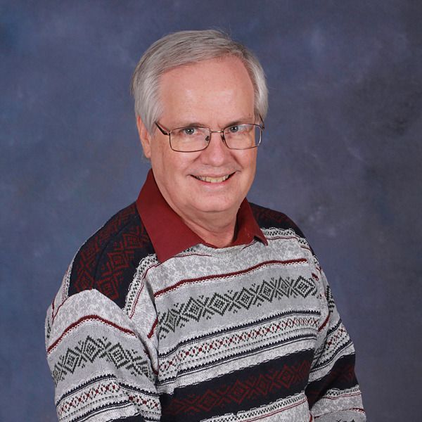 A man wearing glasses and a striped shirt