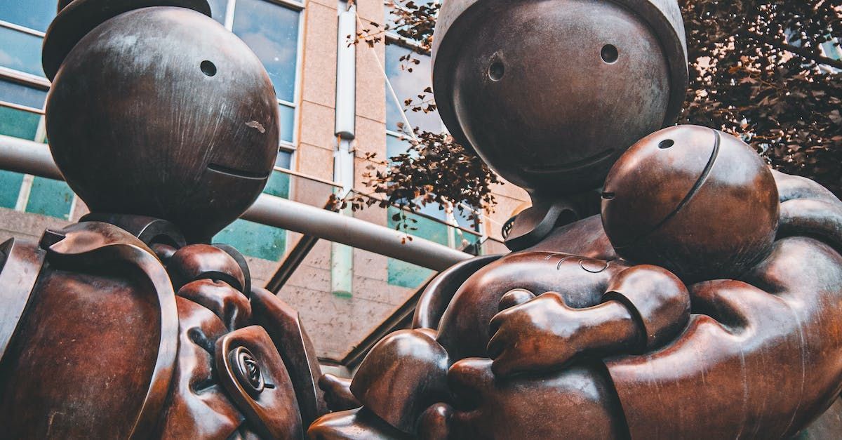 A statue of a man and woman holding a baby.