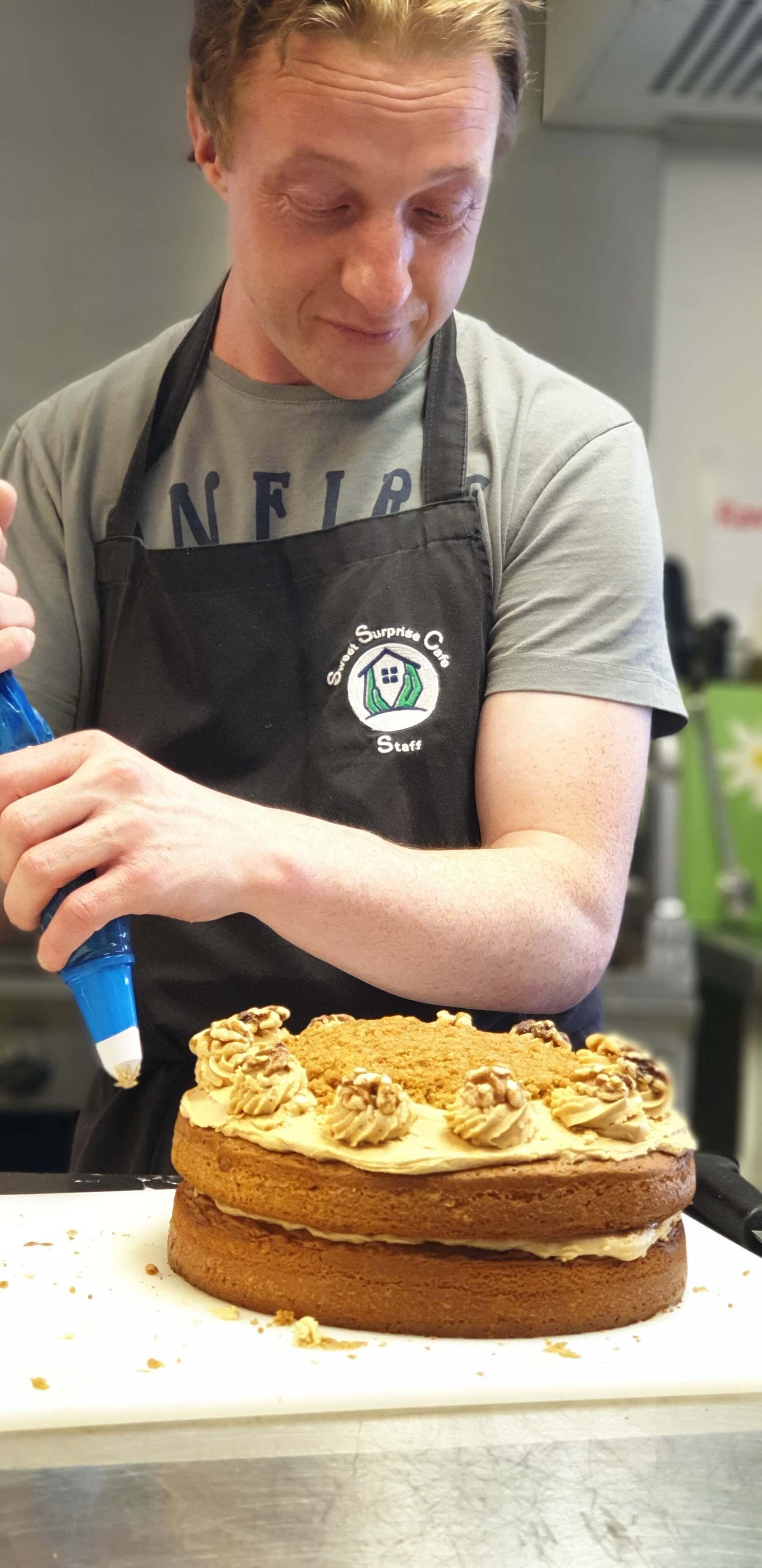 Decorating cake for cafe in local community