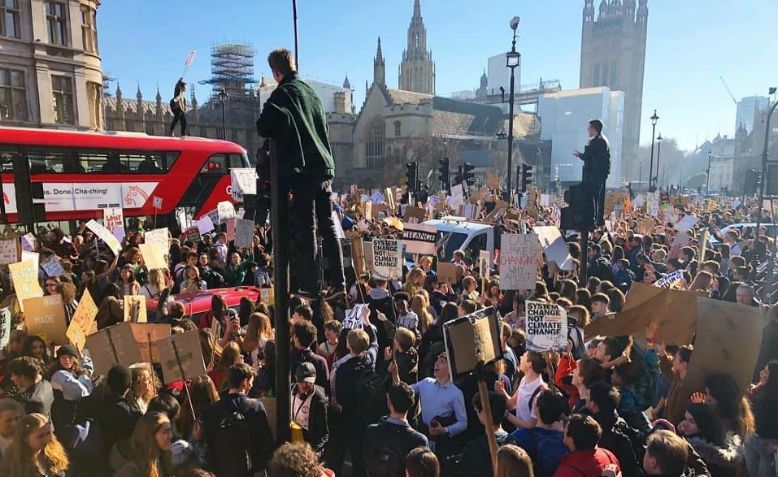 Government building with crowded streets symbolising physical and digital threats to democracy and national security.