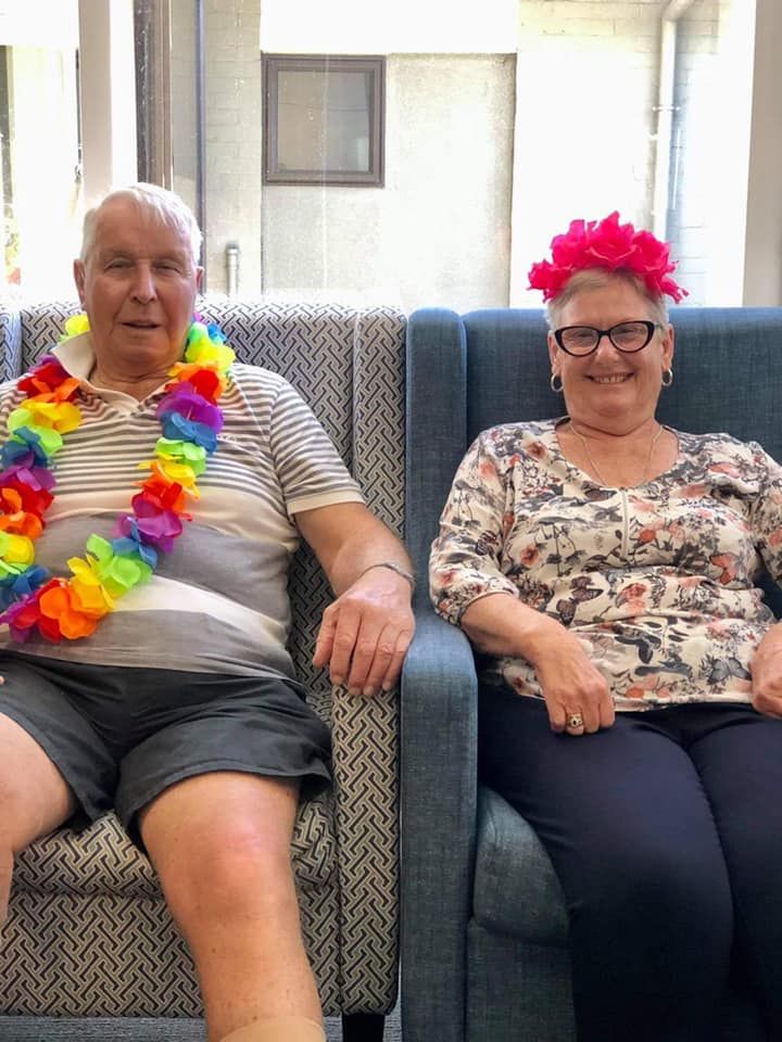 A man and a woman are sitting next to each other in chairs.