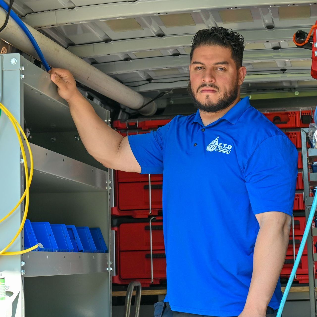 A man wearing a blue shirt that says base on it