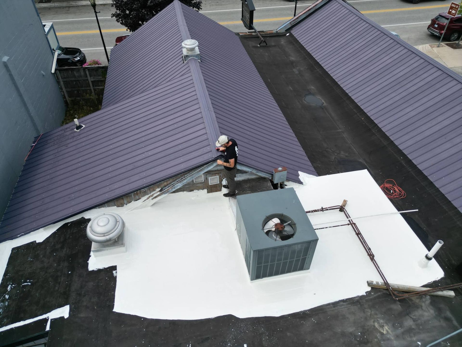 An aerial view of a man standing on the roof of a building.