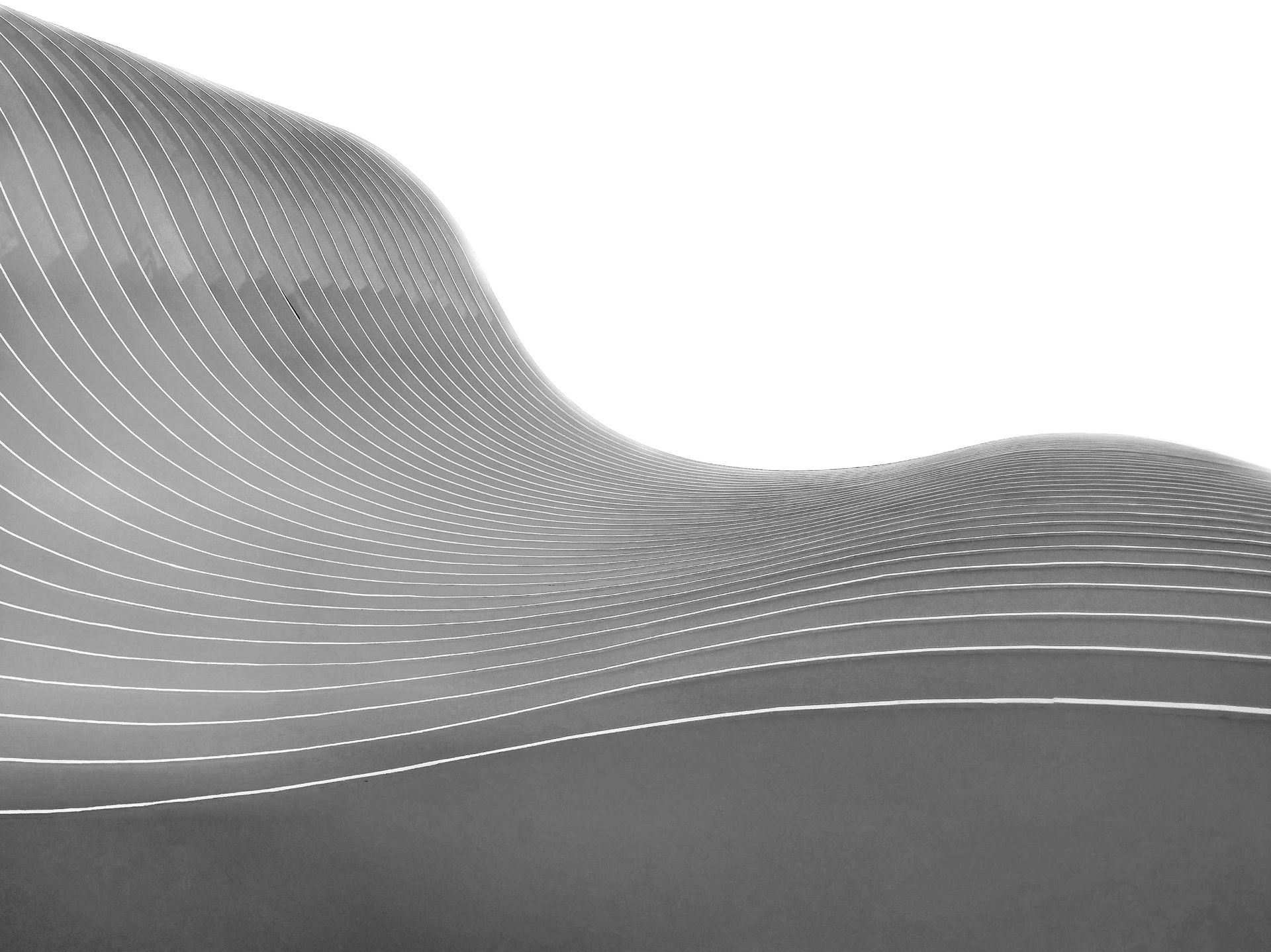 A black and white photo of a curve in the road