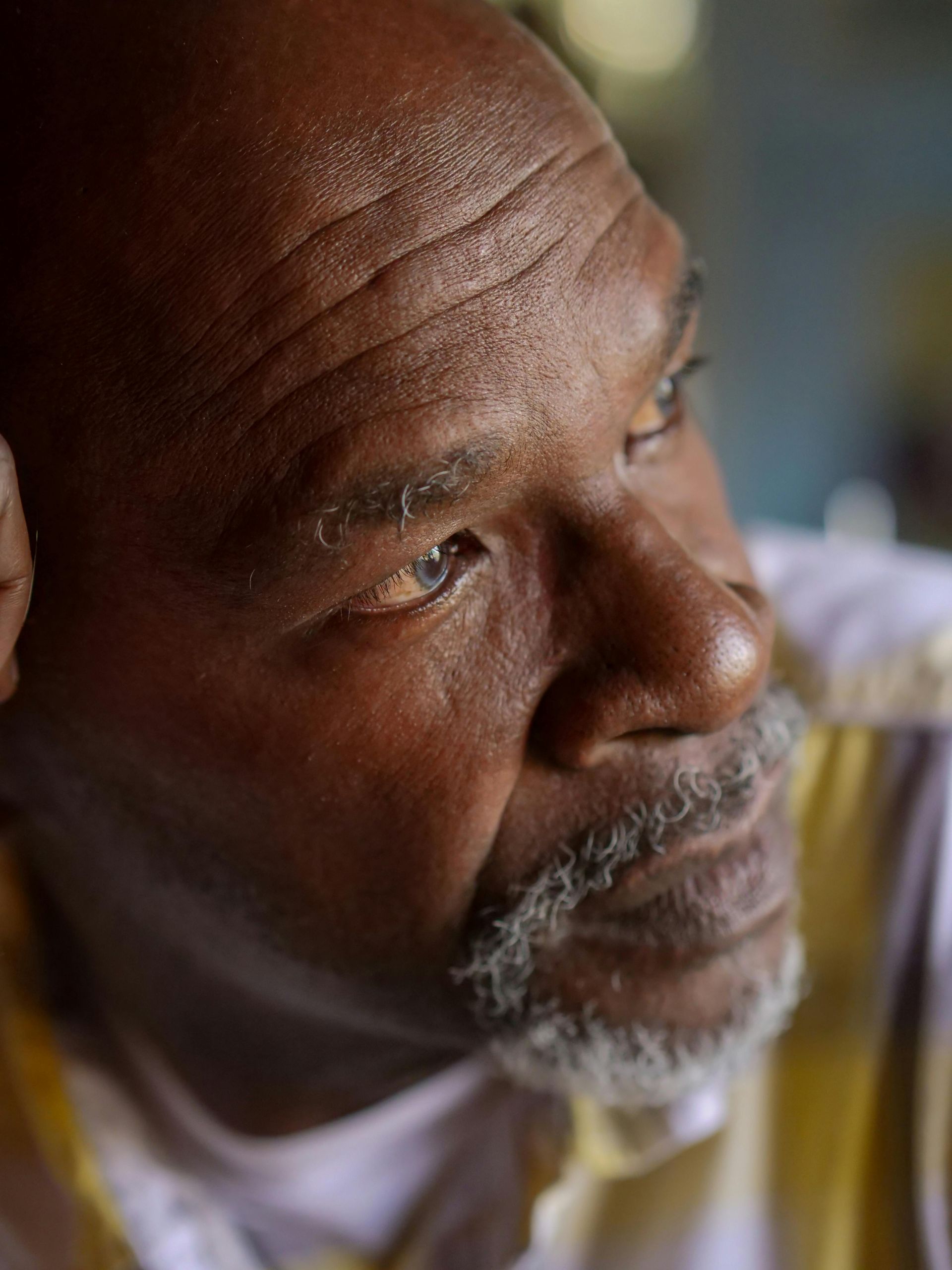 A close up of a man 's face with a beard