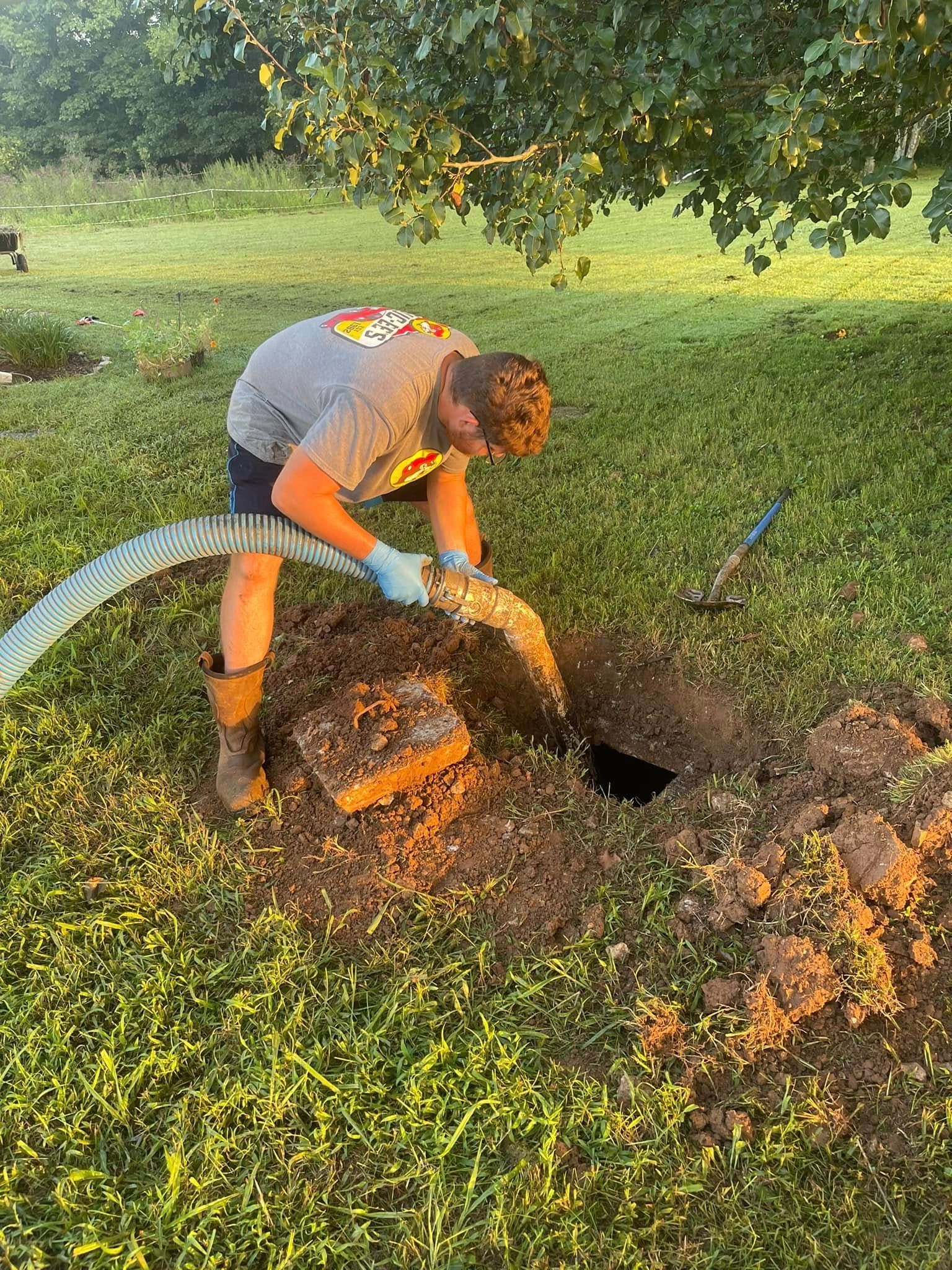 Gray industrial air compressor on wheels in a brick-walled room.