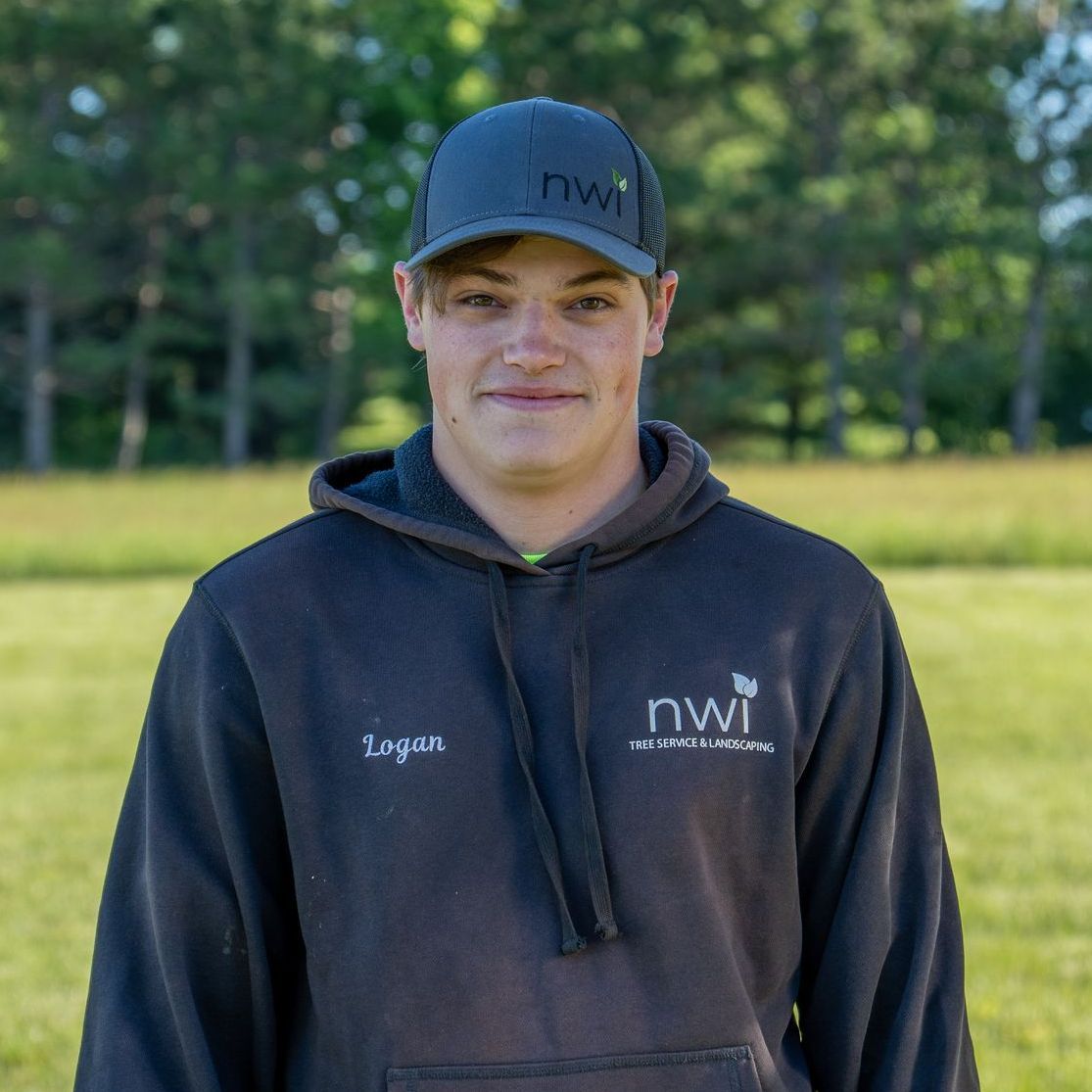 A man wearing a hoodie and a hat with the word nwi on it