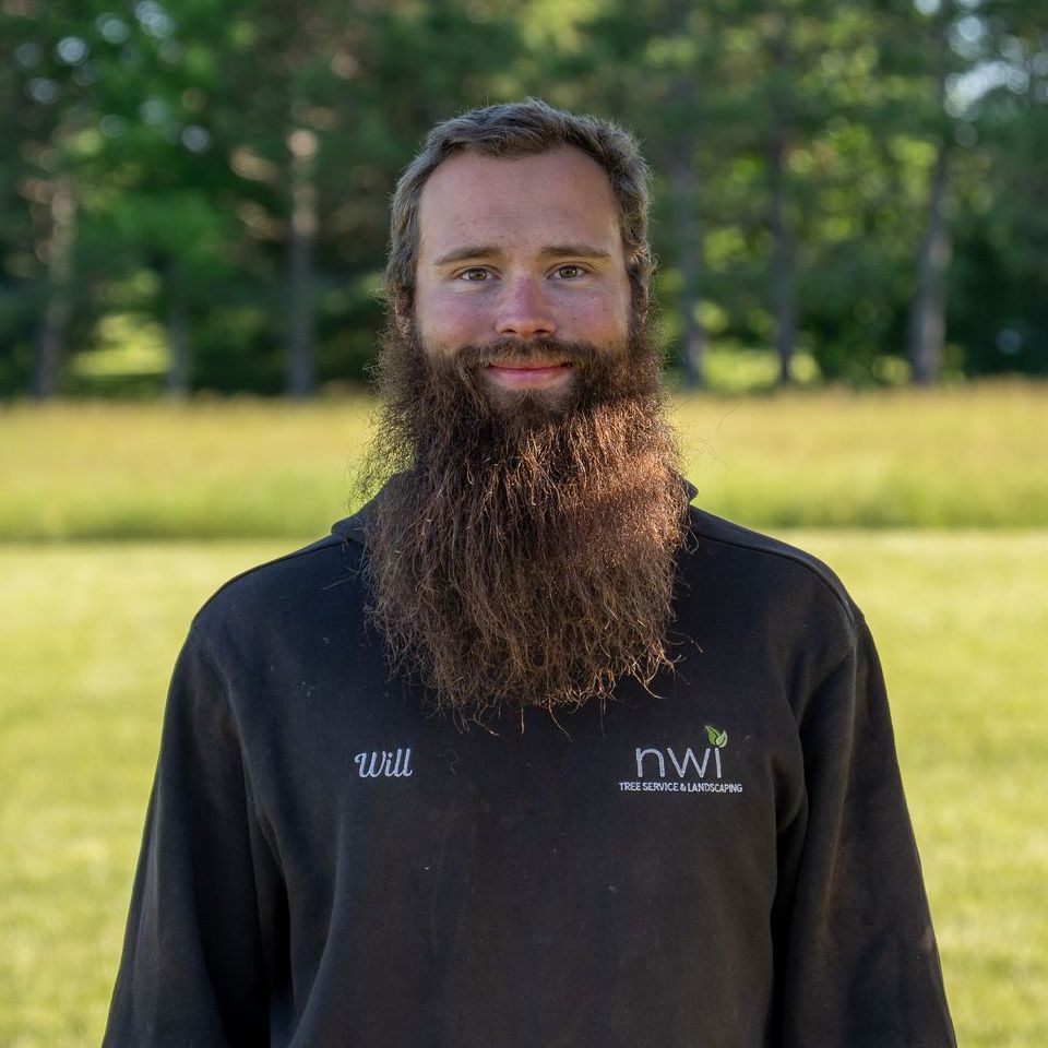 A man with a long beard is wearing a nwi sweatshirt