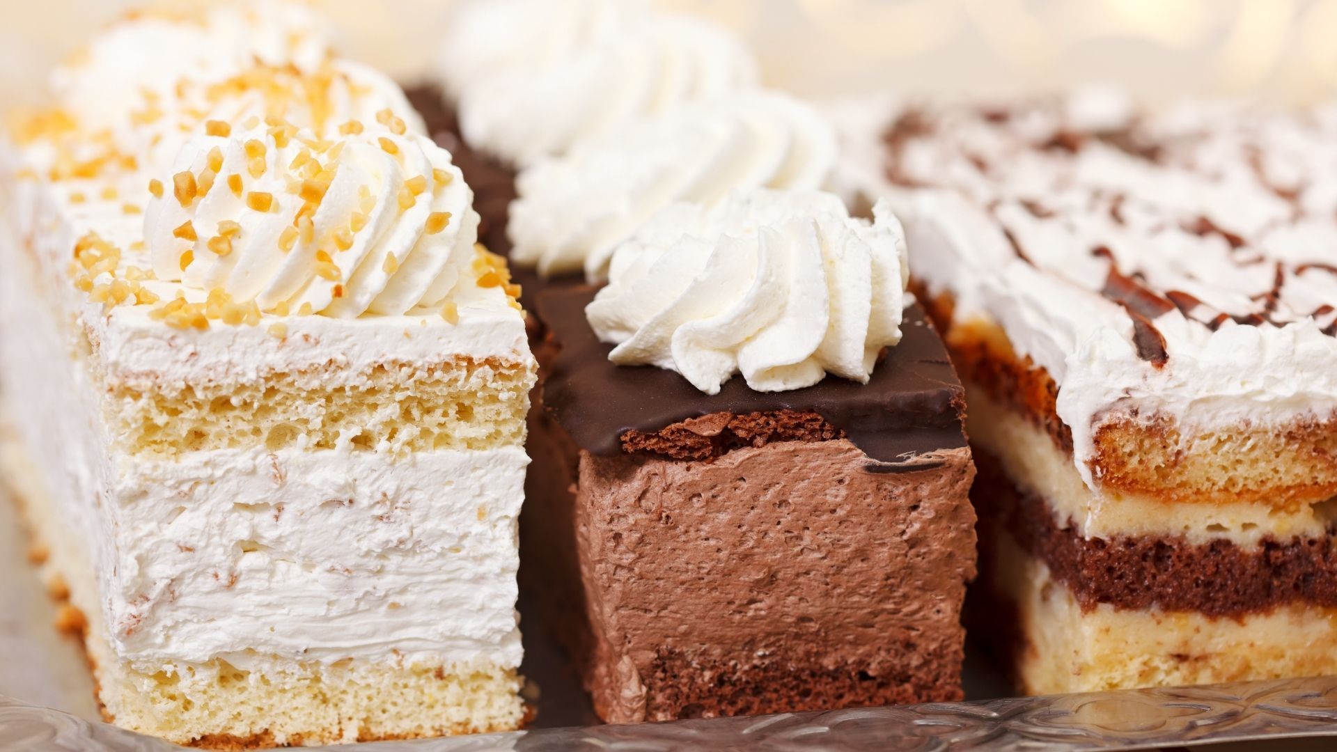 Three rectangular cakes with different toppings.