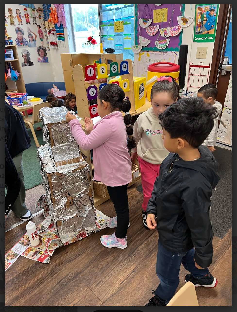 A group of children are playing in a classroom.