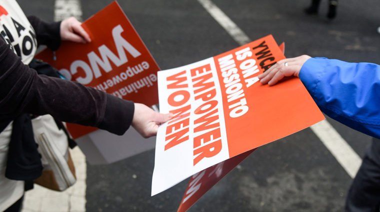 a person holding a sign that says empower women
