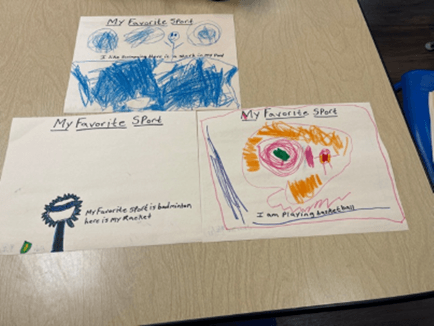 Three children 's drawings on a table one of which says my favorite shirt