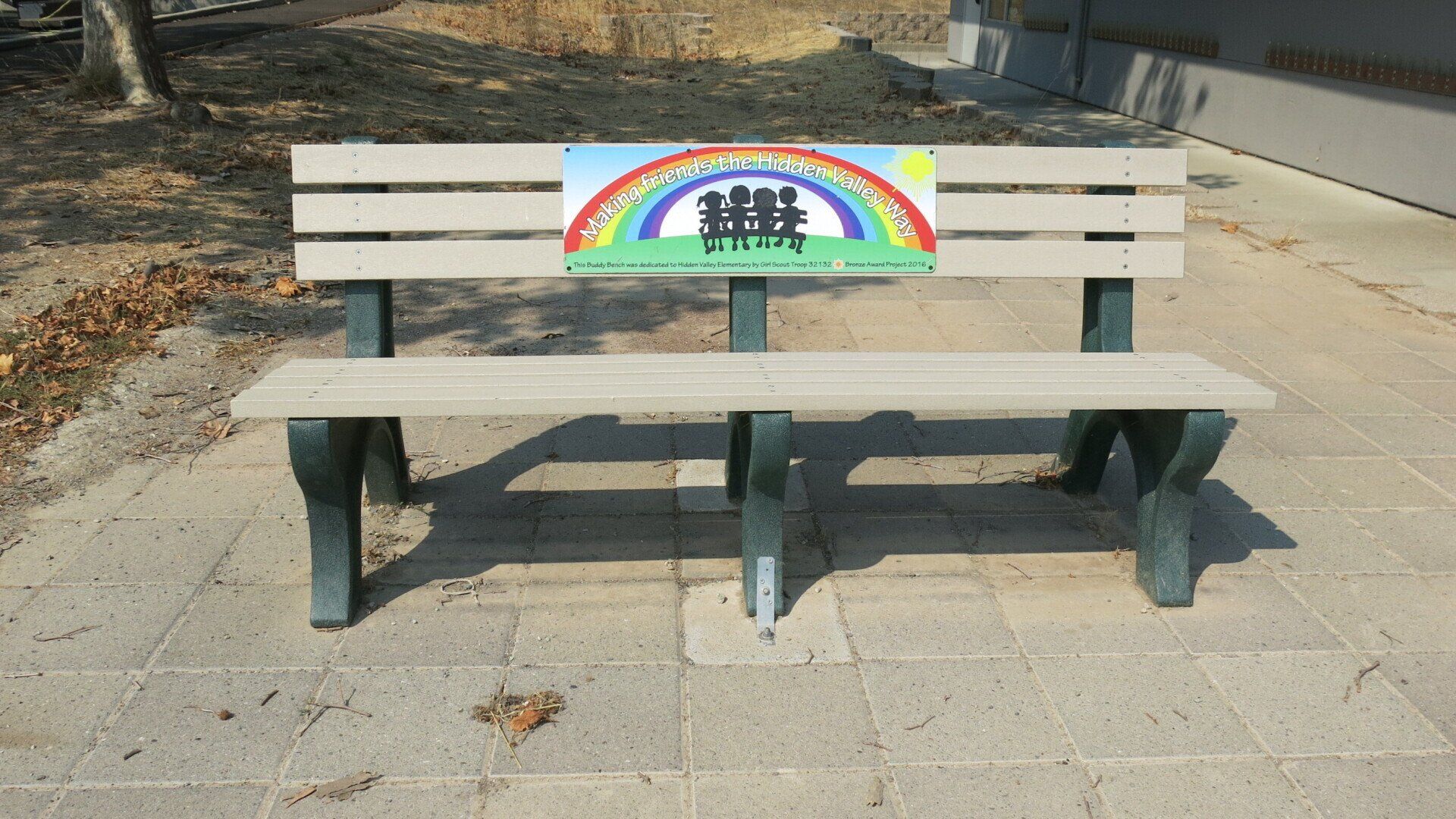 A park bench with a rainbow on it