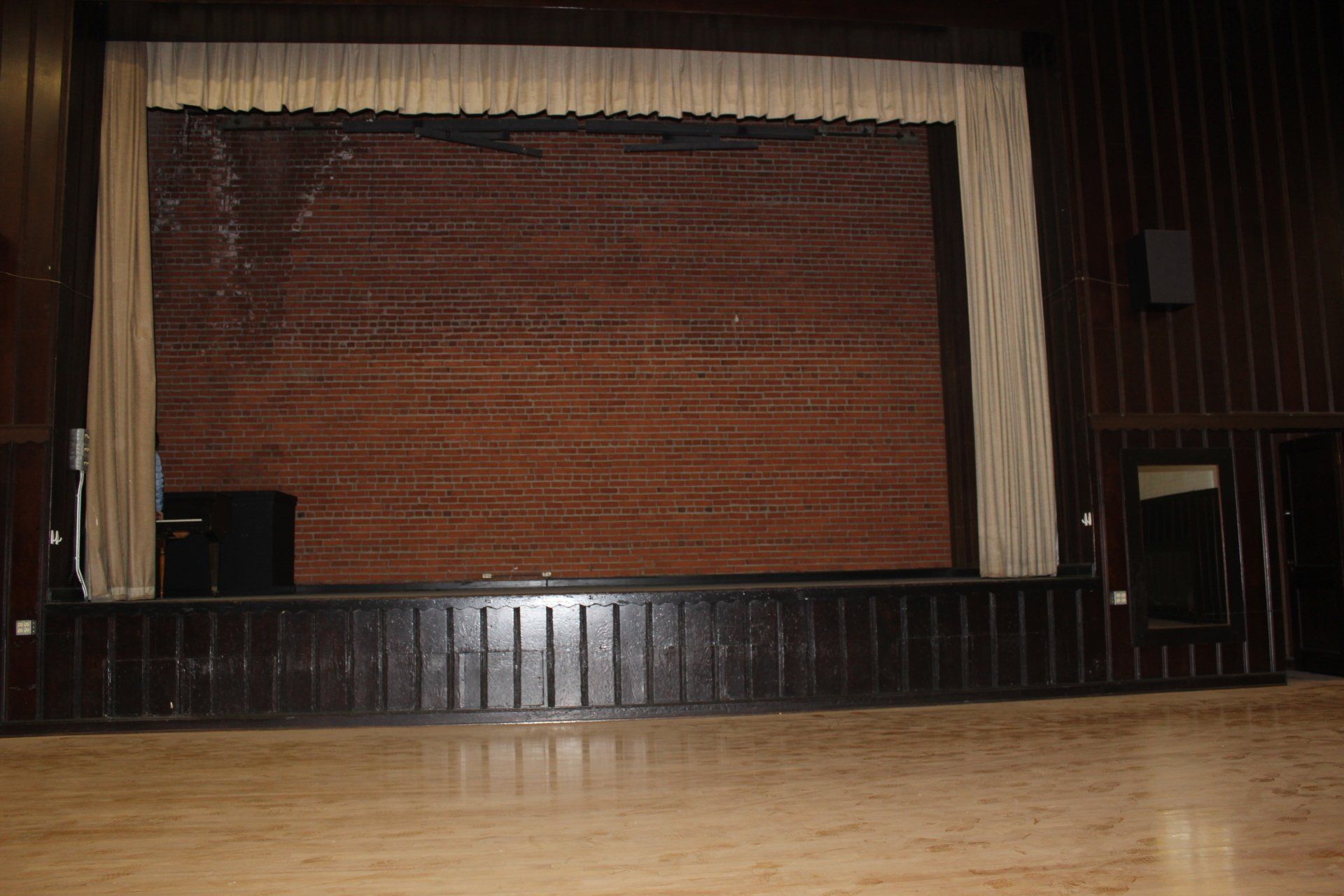 An empty stage with a brick wall behind it