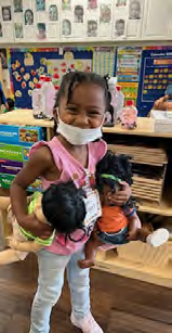 A group of children are sitting at a table playing with watercolors.