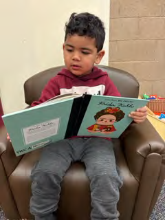 A group of children are sitting around a table in a classroom.