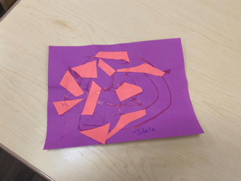 A piece of purple paper with orange triangles on it