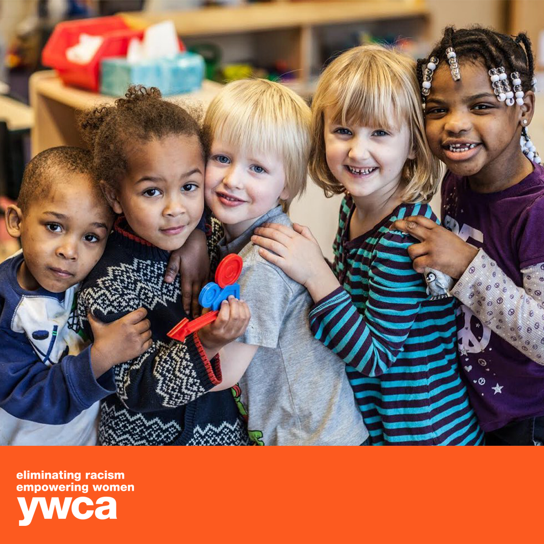 A group of children posing for a picture with ywca written on the bottom