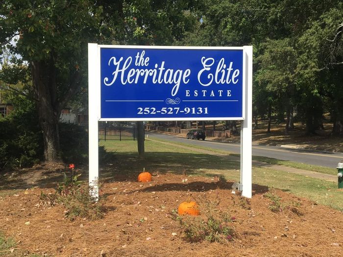 A blue and white sign for the hermitage elite estate