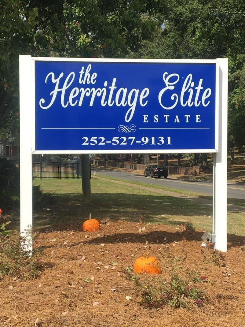 A blue and white sign for the hermitage elite estate