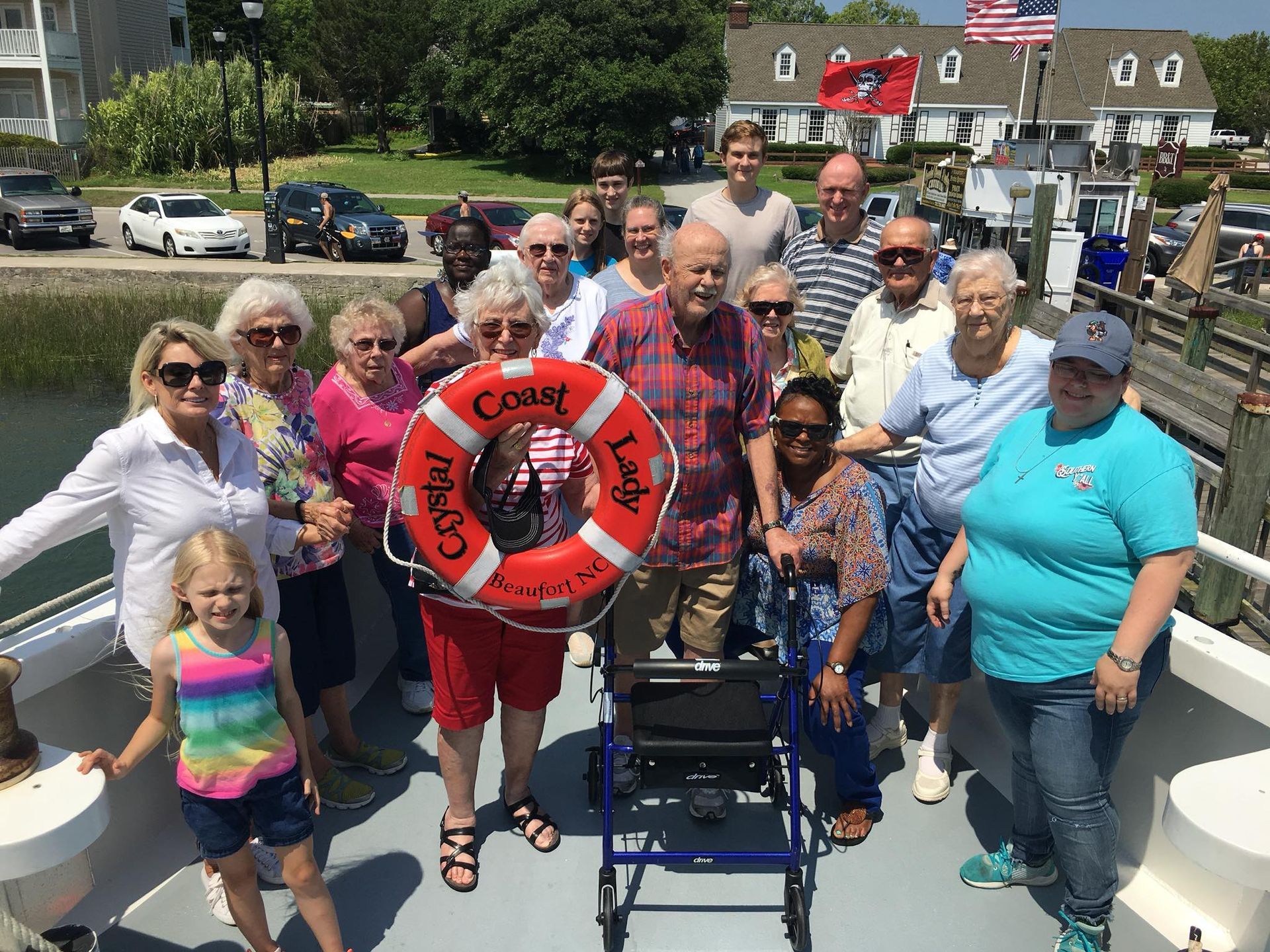 A group of people are posing for a picture on a boat.