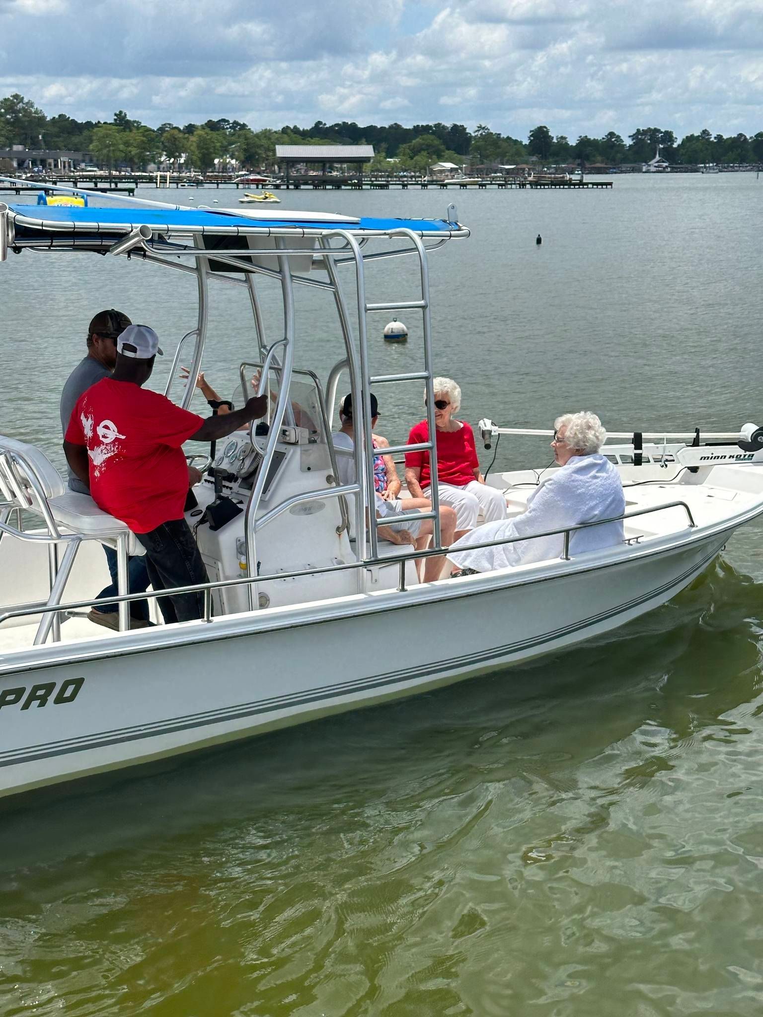 A group of people are sitting on a boat in the water.