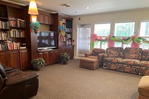 A living room with a couch , chair , and television.