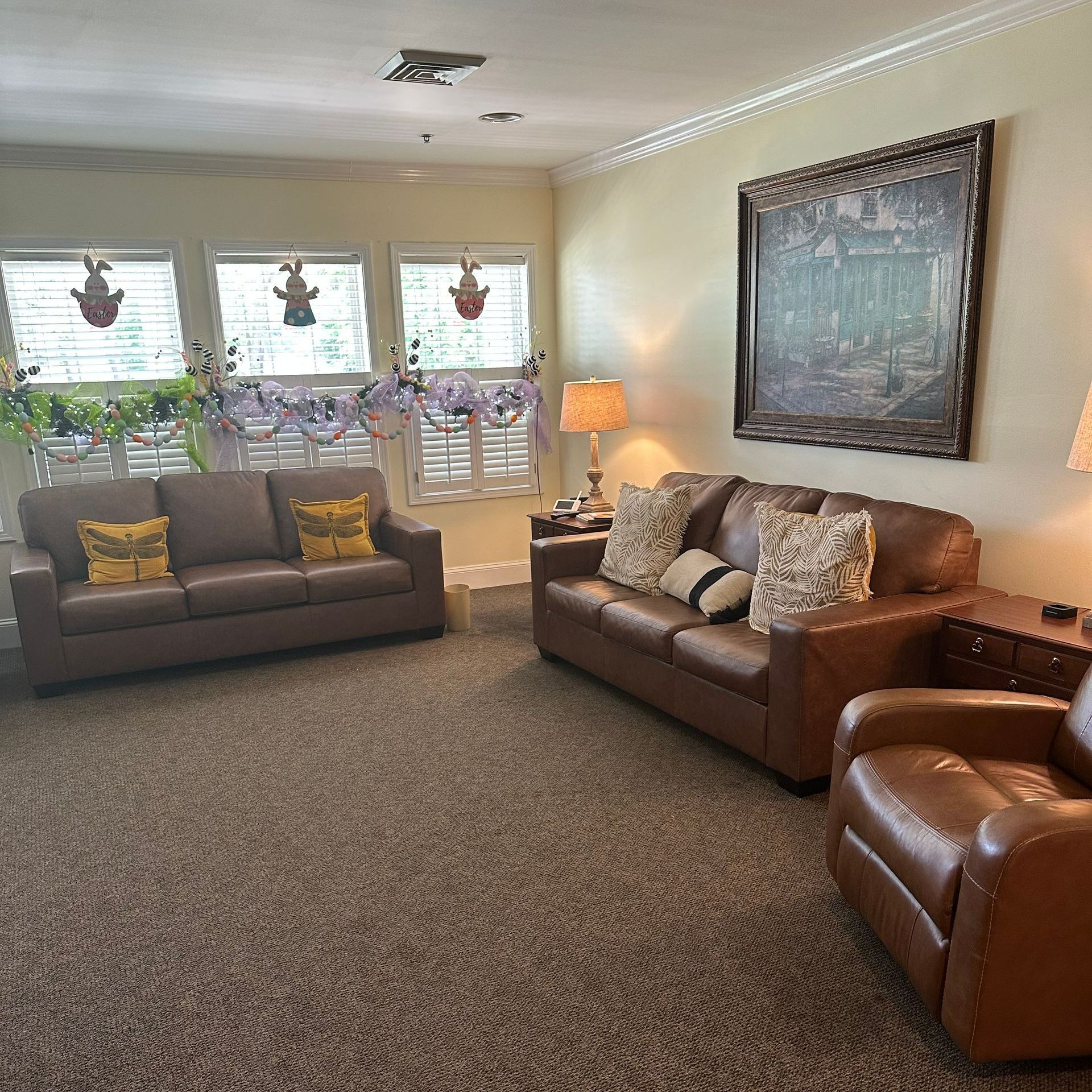 A living room with two couches and two chairs.