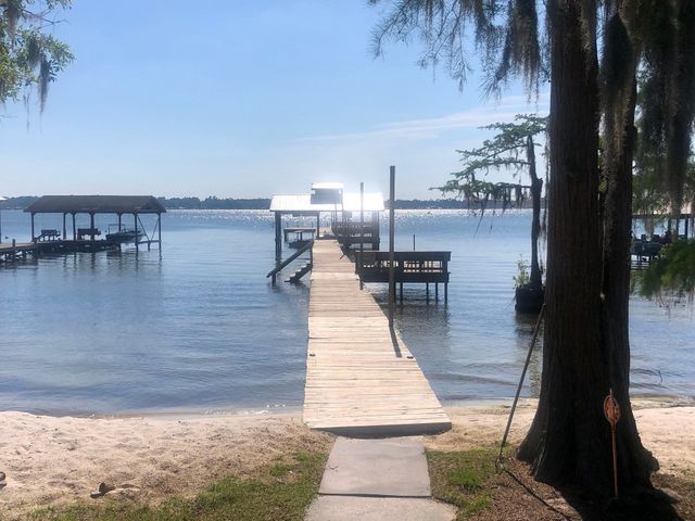 A boat is docked at a dock on a lake